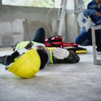 Workplace accidents at construction sites can include incidents such as workers falling from ladders, becoming unconscious due to electric shock, and other unsafe situations.