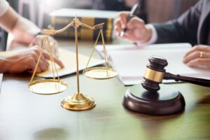 Businesspeople and lawyers discussing contract papers while sitting at a table, representing concepts of law, legal advice, and legal services.