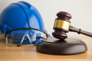 Hammer judge gavel with construction hat helmet, worker safety glasses 