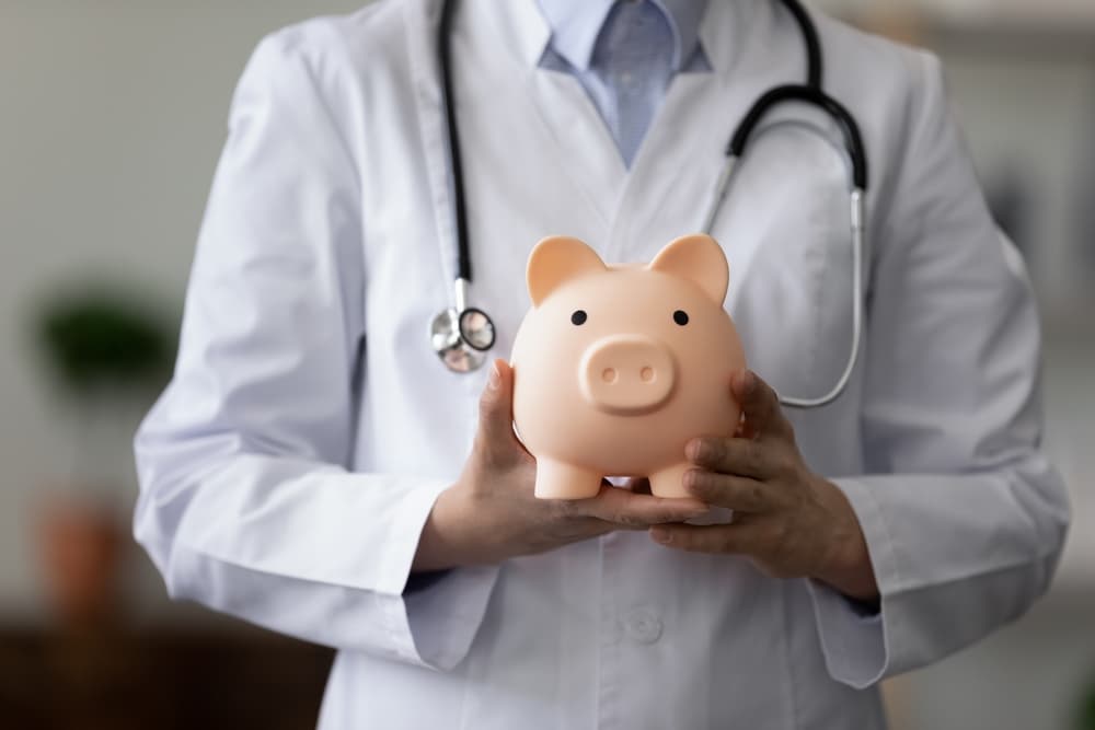 female doctor physician nurse wearing white uniform with stethoscope holding pink piggy bank, medical insurance concept, healthcare and medicine, hospital budget, clinic fees