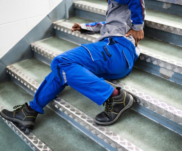 Worker Man Lying On Staircase After Slip And Fall Accident